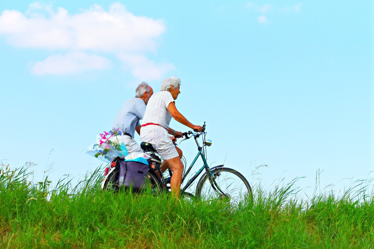 elderly people riding bikes